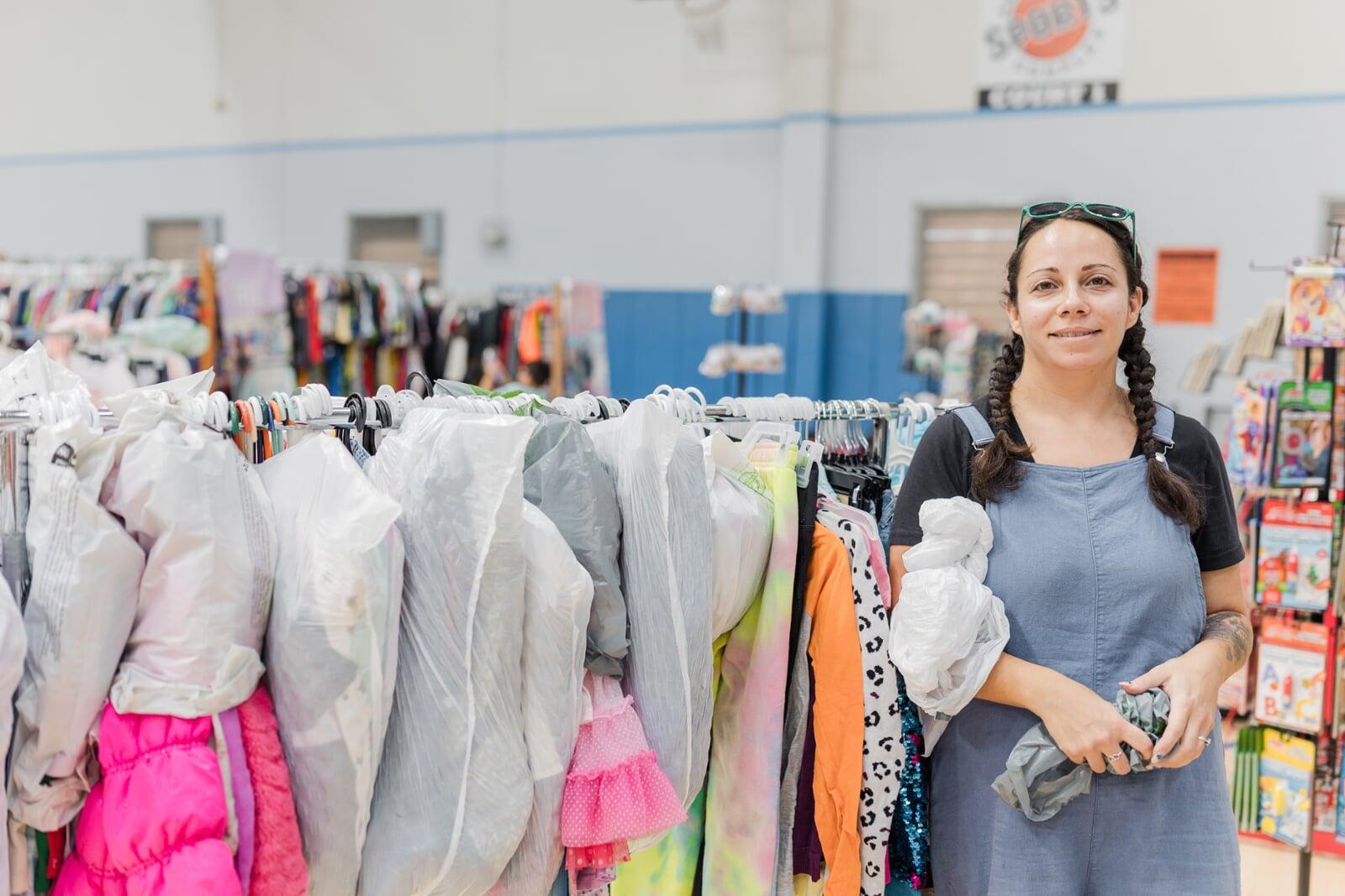 A cashier smiles behind her mask as she gets ready to check out the next happy JBF customer.