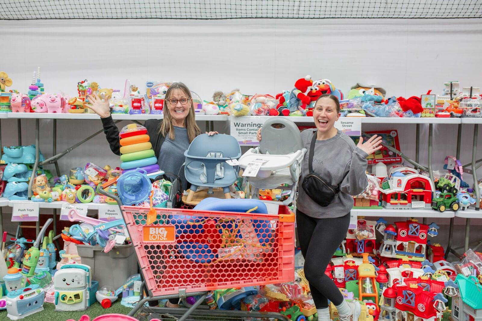 A mother and daughter stand side by side in their masks as they shop their local JBF sale.